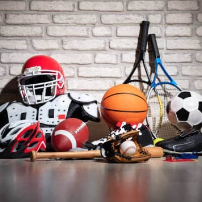 Various Sport Equipment On Floor In Front Of Brick Wall Various Sport Equipment On Floor In Front Of Brick Wall